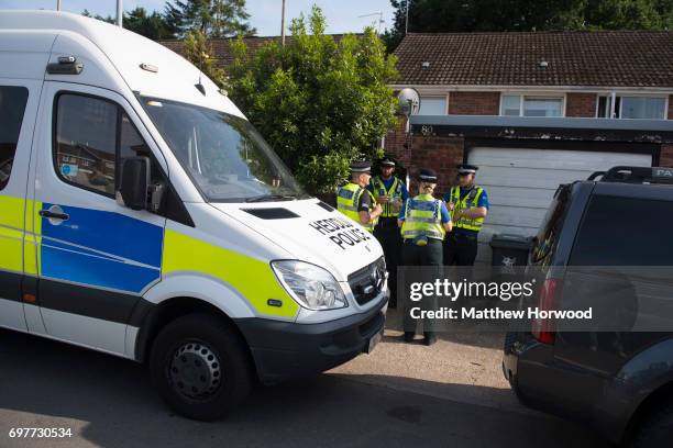Police officers stand outside a property during a search of a house on Glyn Rhosyn, Pentwyn, which is believed to be the home of Darren Osborne, who...