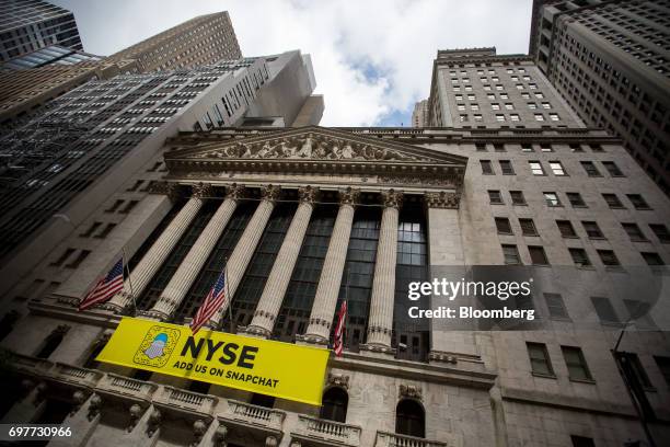 American flags fly outside the New York Stock Exchange in New York, U.S., on Monday, June 19, 2016. U.S. Stocks rose, following a lull in markets...