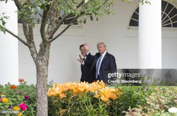 Juan Carlos Varela, Panama's president, left, and U.S. President Donald Trump wave to members of the media while walking towards the Oval Office at...