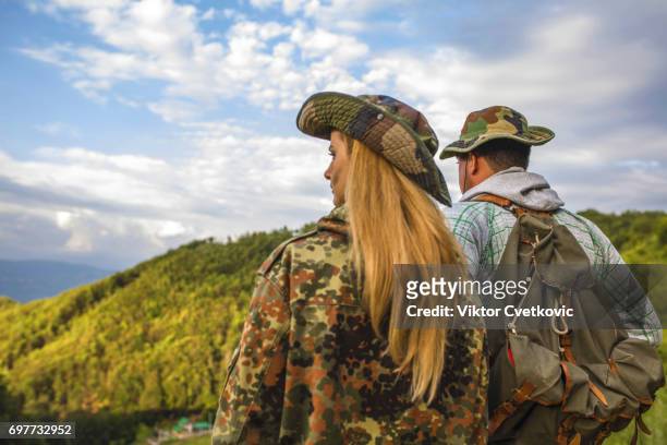 young active couple hiking - spy hunter stock pictures, royalty-free photos & images