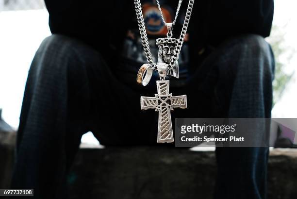 Tony, a patient at a Brooklyn methadone clinic for those addicted to heroin, displays crosses he wears and sprinkles with Holy water as he continues...