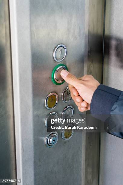 pressing the button in the elevator - pressing elevator button stock pictures, royalty-free photos & images