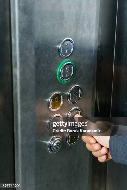 pressing the button in the elevator - pressing elevator button stock pictures, royalty-free photos & images
