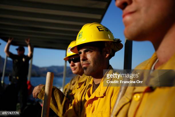 Daniel Johansen II, middle, along with other other Firefighters being transported by Los Angeles County Life guards across Castaic Lake. A...