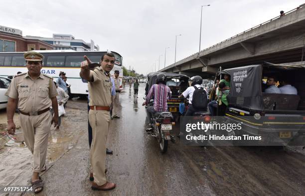 Gurgaon Police Commissioner Sandeep KKhirwar manages traffic with other officials at Hero Honda Chowk, after the heavy rainfall lashed Delhi and NCR...