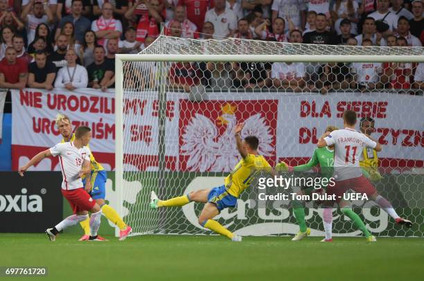 Lukasz Moneta of Poland scores the opening goal during the UEFA European Under-21 Championship Group A match between Poland and Sweden at Lublin...