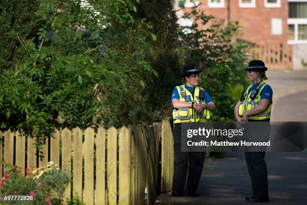Two PCSO's stand outside a property during a search of a house on Glyn Rhosyn, Pentwyn, which is believed to be the home of Darren Osborne, who has...