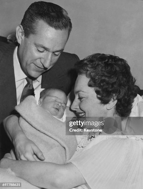 British-American actress Olivia de Havilland and her second husband, French journalist Pierre Galante with their newborn daughter, Gisèle, at the...