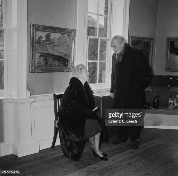 Randolph Churchill , the son of Winston Churchill, with his mother Clementine Churchill at an exhibition of his father's artworks in Colchester, UK,...