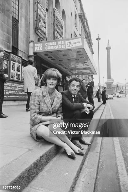 British actor Brian Rix and his wife Elspet Gray outside the Whitehall Theatre, which is showing his Whitehall farce 'Chase Me, Comrade!', London,...