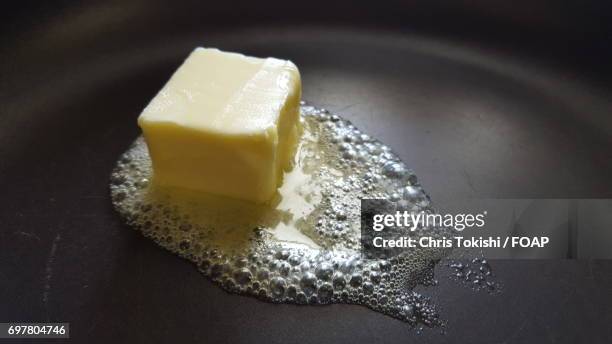 close-up of butter melting on frying pan - バター ストックフォトと画像