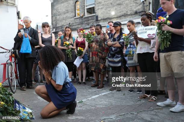 Young woman gestures as she lays flowers outside the Muslim Welfare House near the scene of the attack by Finsbury Park Mosque on June 19, 2017 in...