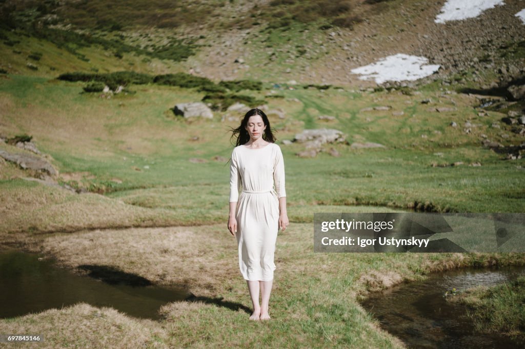 Woman near the river in mountains