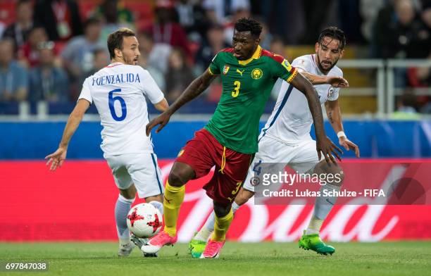 Jose Fuenzalida of Chile, Andre-Frank Zambo Anguissa of Cameroon and Mauricio Isla of Chile fight for the ball during the FIFA Confederations Cup...