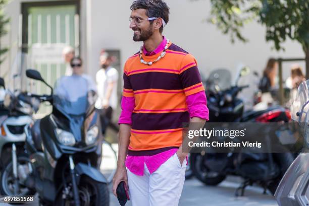 Simone Marchetti wearing a orange, striped tshirt, pink polo shirt with long sleeves, white pants is seen outside Armani during Milan Men's Fashion...