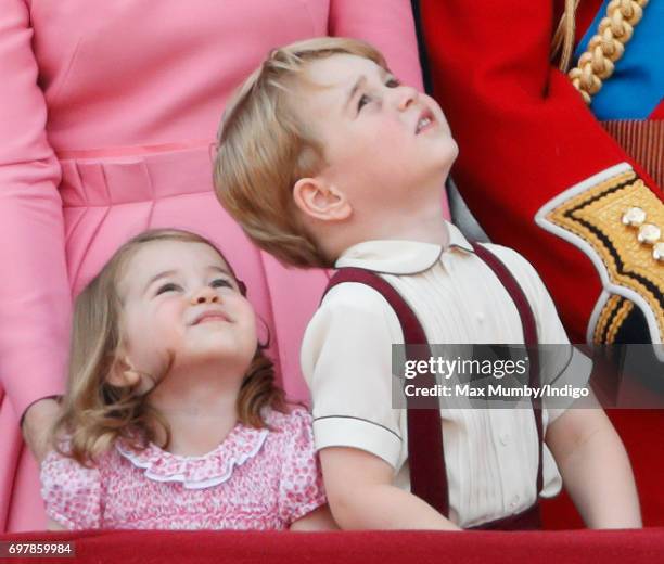 Princess Charlotte of Cambridge and Prince George of Cambridge watch the flypast from the balcony of Buckingham Palace during the annual Trooping the...