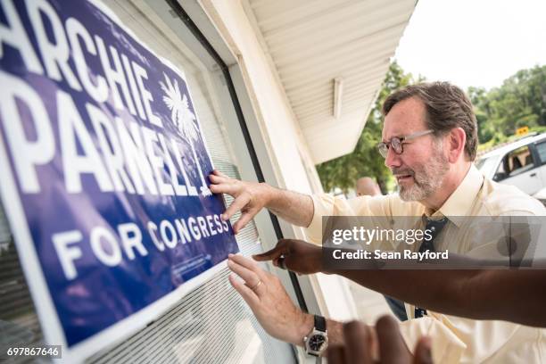 Democratic congressional candidate Archie Parnell hangs up a campaign sign June 19, 2017 in Bishopville, South Carolina. Voters will choose between...