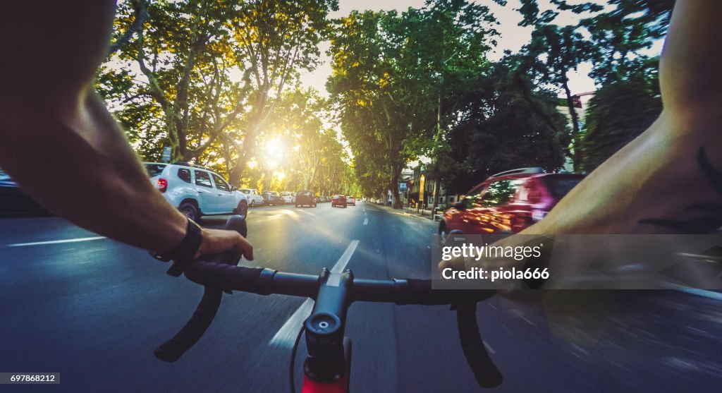 POV commuter riding a road racing bicycle in the city