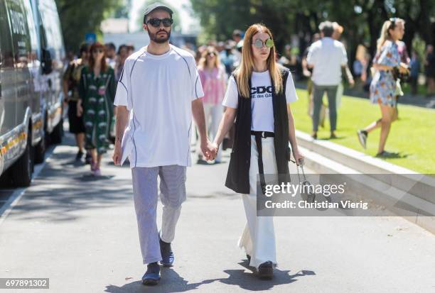 Couple is seen outside Armani during Milan Men's Fashion Week Spring/Summer 2018 on June 19, 2017 in Milan, Italy.