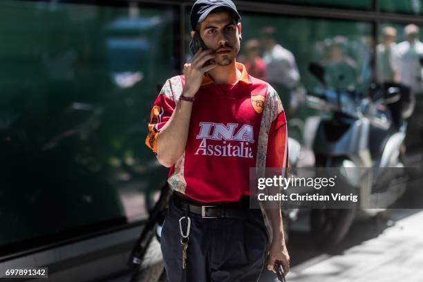 Guest wearing a football tshirt of Totti is seen outside Armani during Milan Men's Fashion Week Spring/Summer 2018 on June 19, 2017 in Milan, Italy.