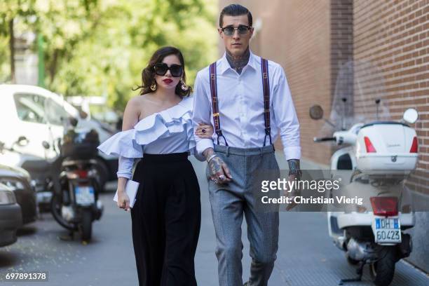 Couple Jimmy Q wearing grey pants, suspenders, white button shirt and Jet Luna wearing an off shoulder top, black pants is seen outside Fendi during...