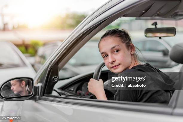 ready for the next destination, checking behind her - car turning stock pictures, royalty-free photos & images