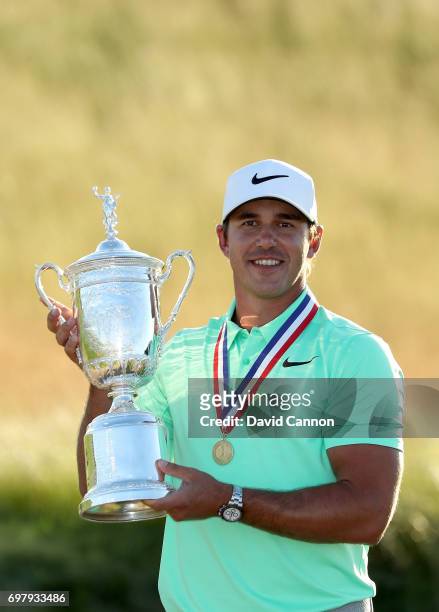 Brooks Koepka of the United States holds the U.S.Open trophy wearing the Jack Nicklaus medal after his four shot win in the final round of the 117th...