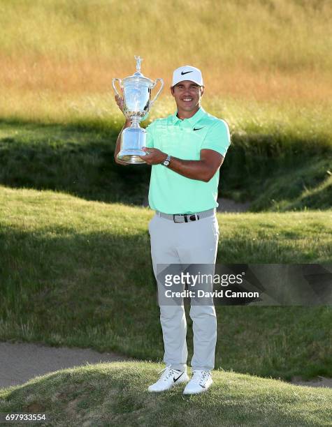 Brooks Koepka of the United States holds the U.S.Open trophy after his four shot win in the final round of the 117th US Open Championship at Erin...