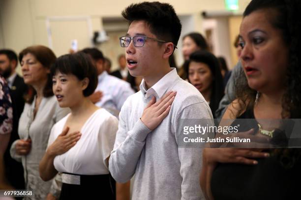 Newly naturalized citizens recite the Pledge of Allegiance during a naturalization ceremony on June 19, 2017 in San Francisco, California. 29 former...