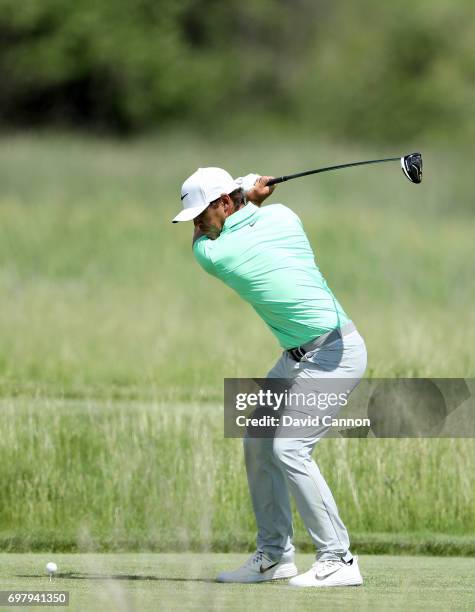 Brooks Koepka of the United States plays his tee shot at the par 4, second hole during the final round of the 117th US Open Championship at Erin...