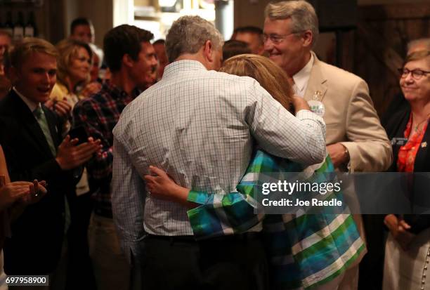 Republican candidate Karen Handel is hugged by her husband Steve Handel after speaking during a campaign stop at Houck's Grille as she runs for...