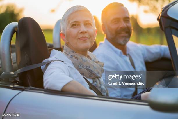 mature couple at car - convertible car stock pictures, royalty-free photos & images