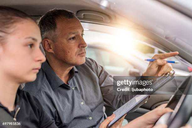 american teen learning driver's education - driving instructor stock pictures, royalty-free photos & images