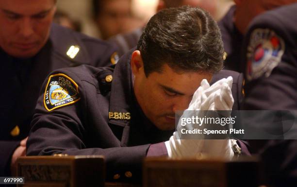 Police officer prays at the funeral mass for New York police officer Moira Smith February 14, 2002 at St. Patricks Cathedral in New York City. Smith...