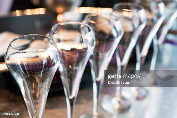 an row of champagne flutes for celebration event - galadinner stock pictures, royalty-free photos & images