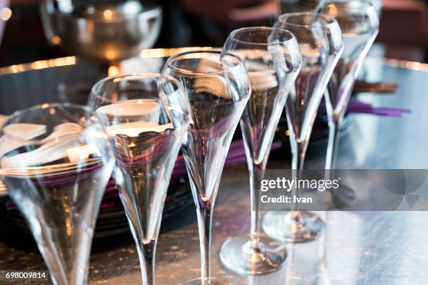 an row of champagne flutes for celebration event - christmas gala stock pictures, royalty-free photos & images