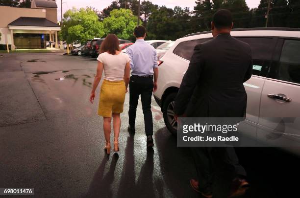 Democratic candidate Jon Ossoff and his fiancee, Alisha Kramer, walk to their vehicle after holding a rally to thank volunteers and supporters on the...