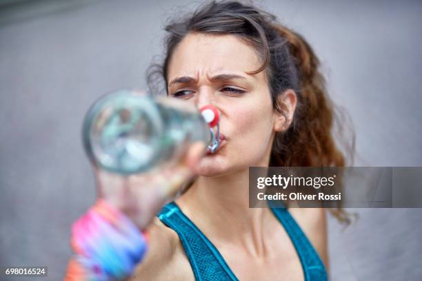 active woman drinking water from bottle - running refreshment stock pictures, royalty-free photos & images