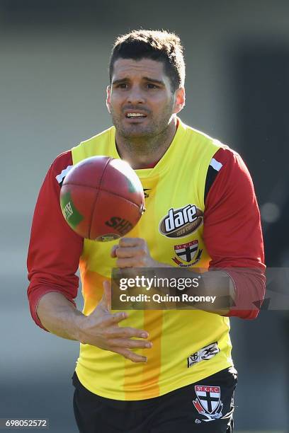 Leigh Montagna of the Saints handballs during a St Kilda Saints AFL training session at Trevor Barker Beach Oval on June 20, 2017 in Melbourne,...