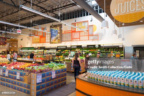 Shoppers browse the produce section at the Whole Foods Market grocery store in Dublin, California, June 16, 2017. .