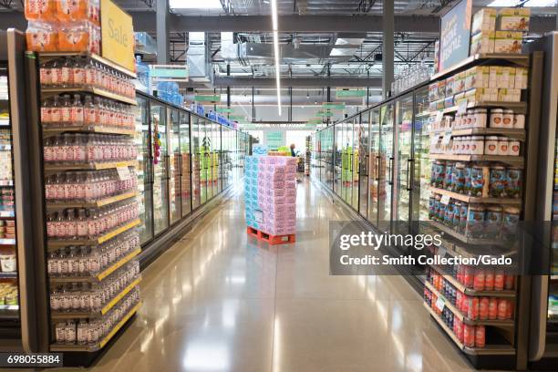 View down a refrigerated food aisle at the Whole Foods Market grocery store in Dublin, California, June 16, 2017. .