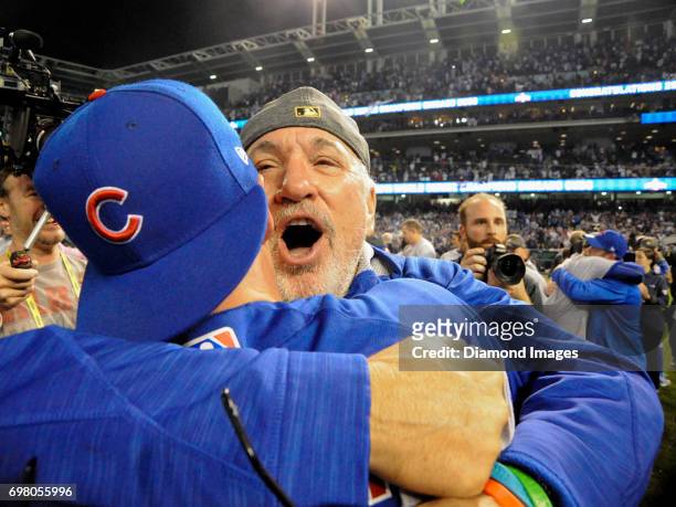 Manager Joe Maddon of the Chicago Cubs embraces pinch runner Chris Coghlan after winning Game 7 of the World Series against the Cleveland Indians on...