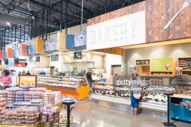 Shoppers visit the bakery section at the Whole Foods Market grocery store in Dublin, California, June 16, 2017. .