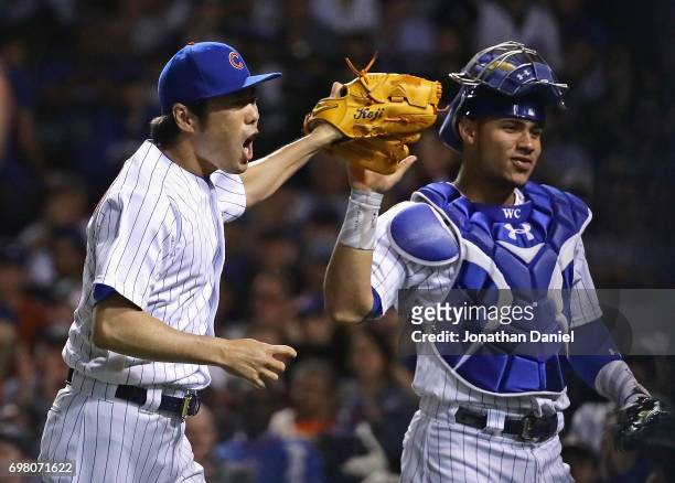 Koji Uehara of the Chicago Cubs celebrates with Willson Contreras after pitching a scoreless 8th inning against the San Diego Padres at Wrigley Field...