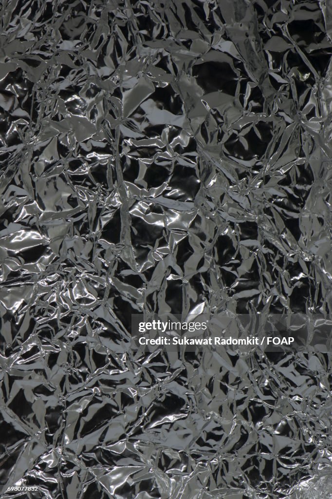 Crumpled silver paper texture background