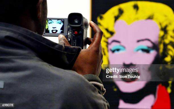 Spectator films "Licorice Marilyn" , a painting at the Andy Warhol retrospective exhibition February 5, 2002 at the Tate Modern Gallery in London....