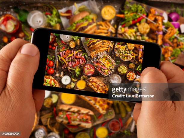 food selfie of hand held bbq favorites - finger bun stock pictures, royalty-free photos & images