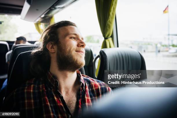 young man relaxing during a bus trip - journey stock-fotos und bilder