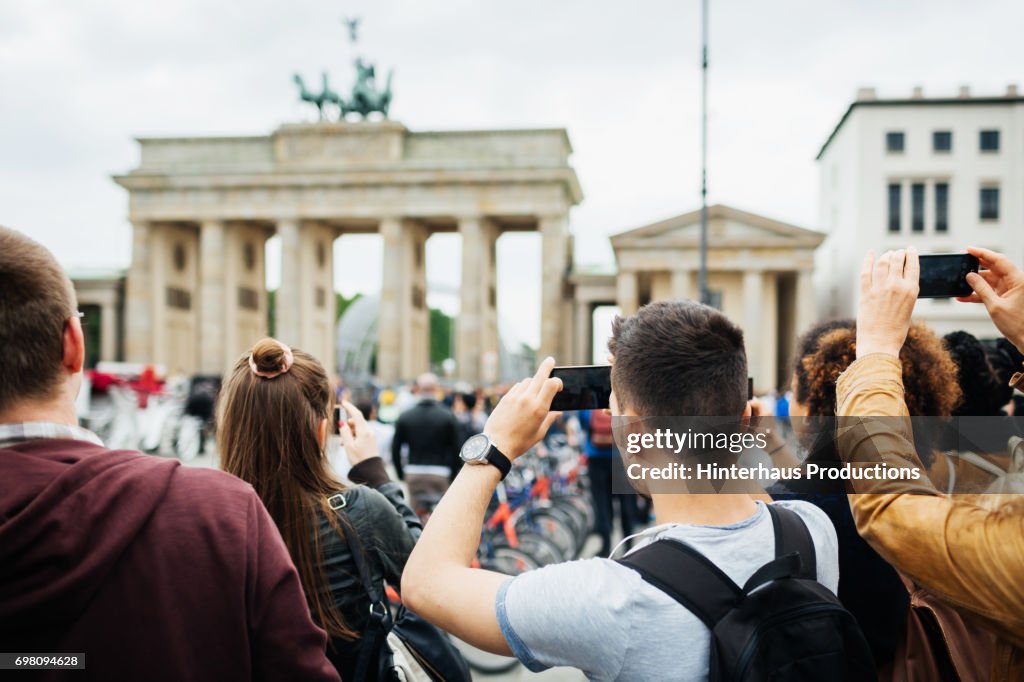 Group Of People Travelling Together Take Pictures Of Brandenburg Gate