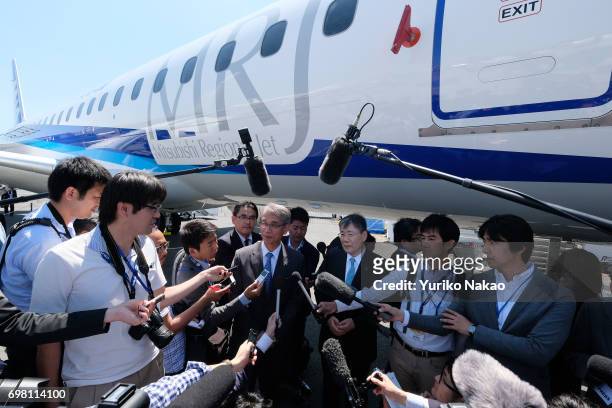 Hisakazu Mizutani, Mitsubishi Aircraft Corporation's president is surrounded by journalists front of the third Flight Test Aircraft of Mitsubishi...